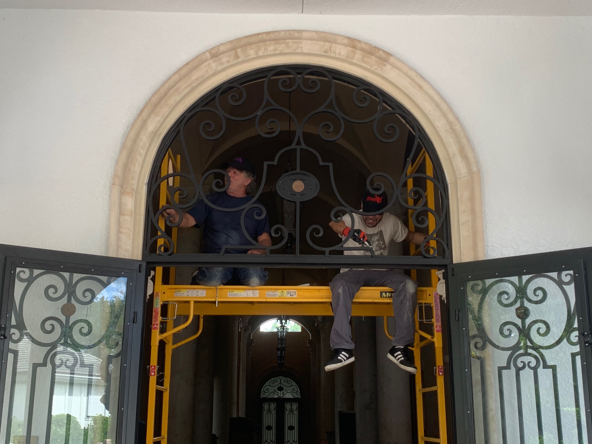 Glass on an iron entrance door and transom needed to be replaced due to glass delamination.